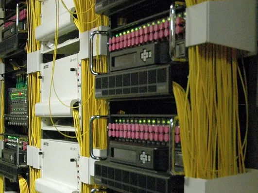 Organized fiber and network cabling in a commercial equipment rack.