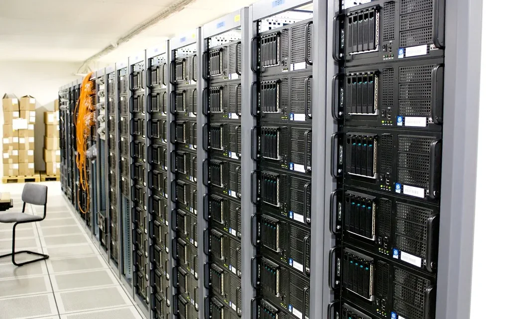 Aligned equipment racks in a commercial server room.