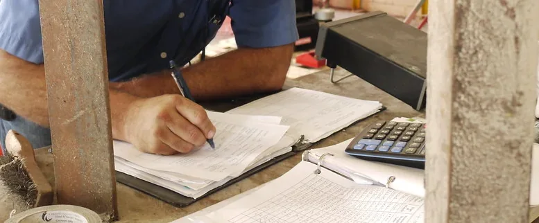 Technician documenting conditions in a commercial equipment area.